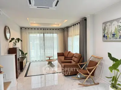 Spacious living room with modern furniture and large windows for natural light.