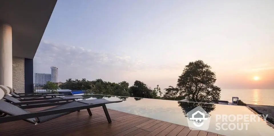 Luxurious infinity pool with stunning ocean view at sunset, perfect for relaxation and leisure.