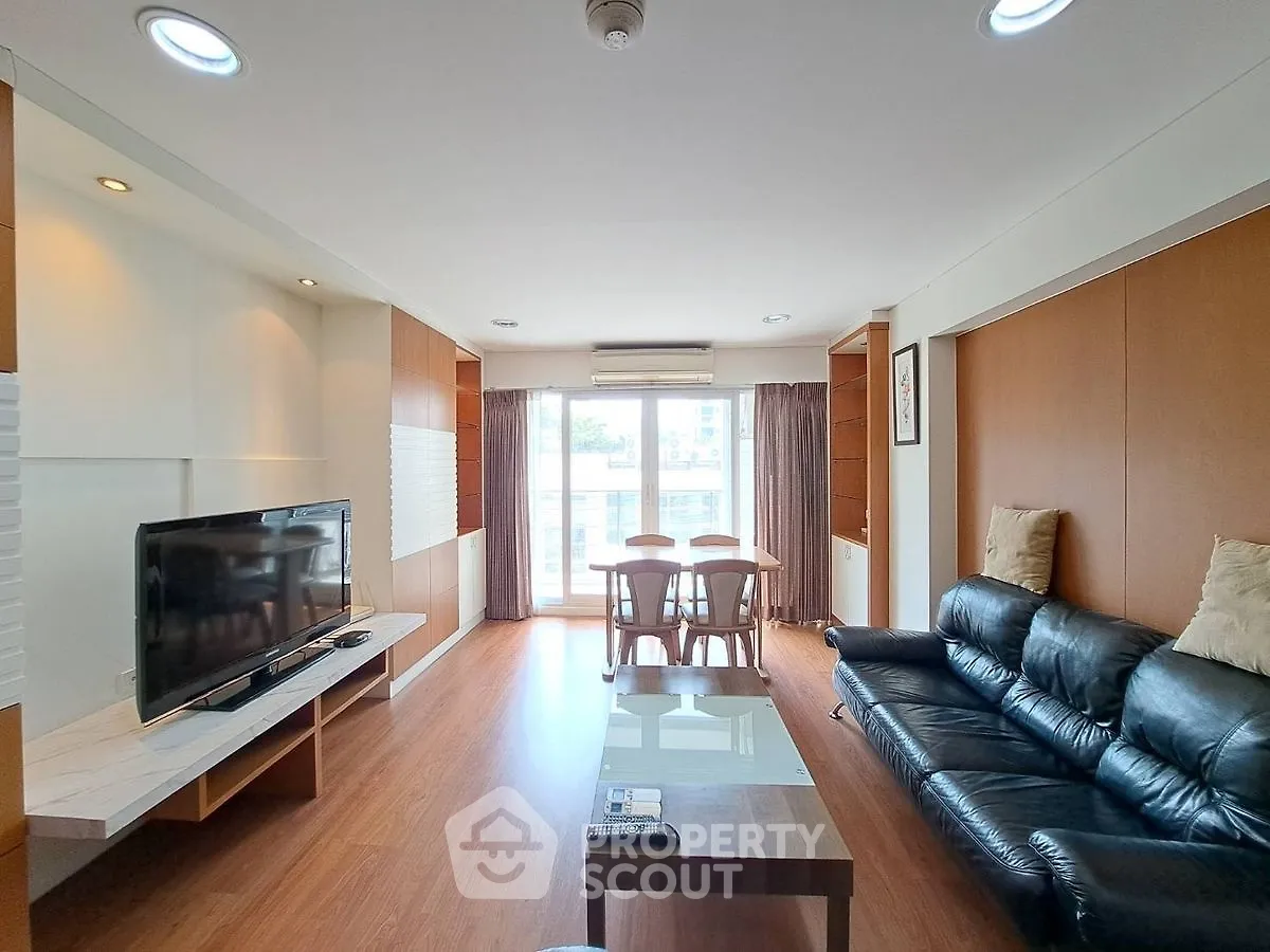 Spacious living room with modern decor and large windows for natural light.