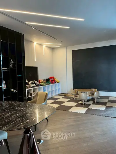 Modern playroom with stylish furniture and large chalkboard wall