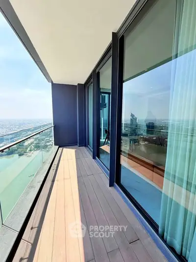 Luxurious high-rise balcony with stunning city and water views, perfect for relaxation and entertainment.
