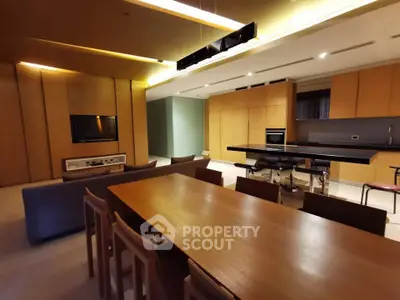 Luxurious open-plan living and dining area with modern kitchen and sleek design.