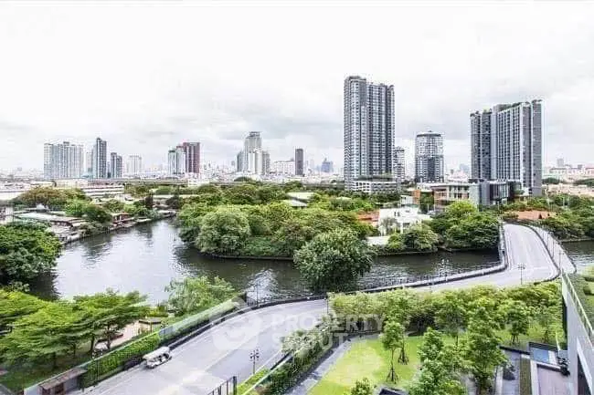 Stunning cityscape view with lush greenery and river, perfect urban living.