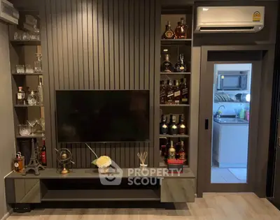 Stylish living room with modern TV setup and built-in shelves showcasing elegant decor.