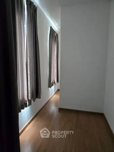 Bright hallway with wooden flooring and elegant curtains in modern home