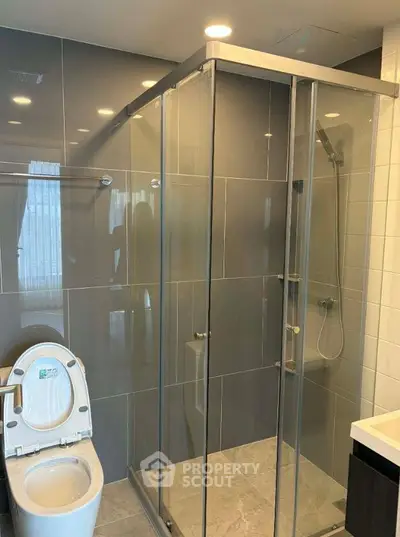 Modern bathroom with glass shower enclosure and sleek tile design