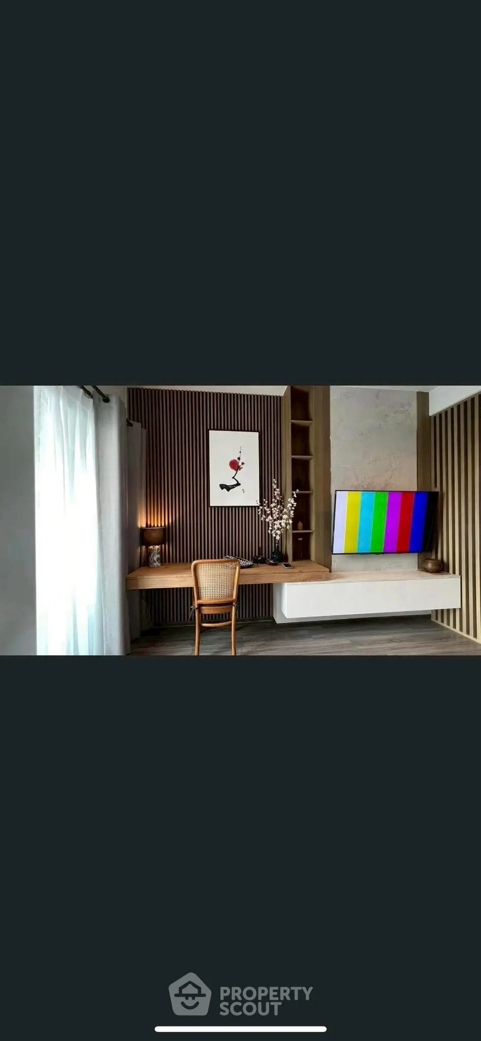 Modern living room with stylish decor and wall-mounted TV, featuring elegant wooden accents and natural light.