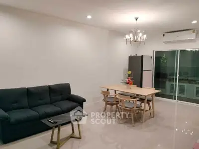 Modern living room with elegant chandelier and cozy seating area