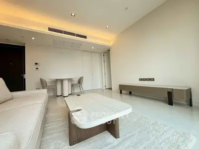 Spacious modern living room with minimalist furniture and elegant lighting