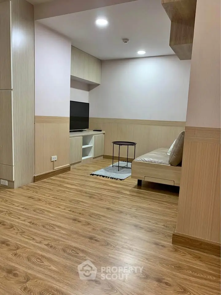 Modern living room with wooden flooring and cozy seating area