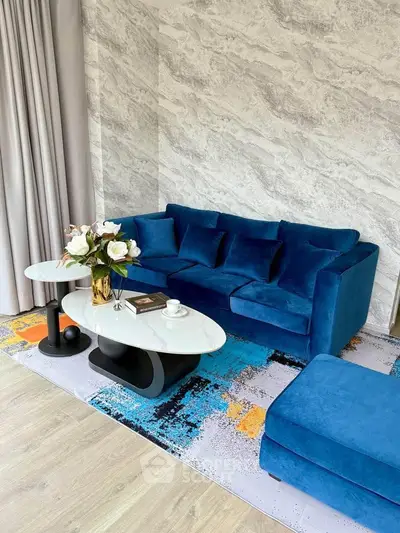 Stylish living room with blue velvet sofa and modern decor