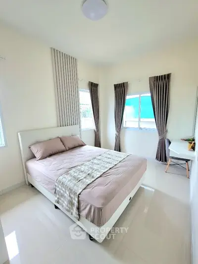 Bright and airy bedroom with modern decor and large windows