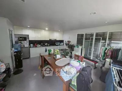 Spacious kitchen with open layout and dining area, featuring modern appliances and ample natural light.