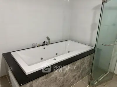 Luxurious bathroom with modern bathtub and glass shower enclosure