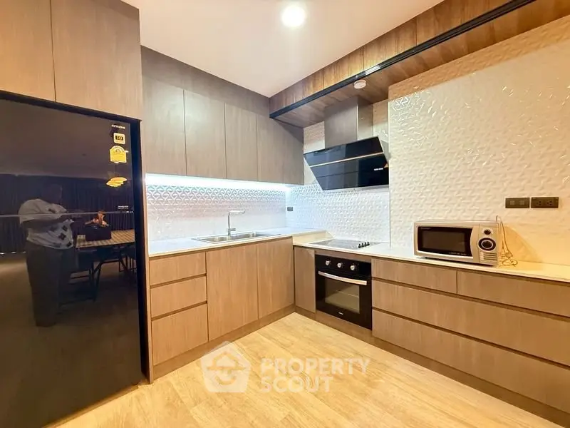 Modern kitchen with sleek wooden cabinets and built-in appliances