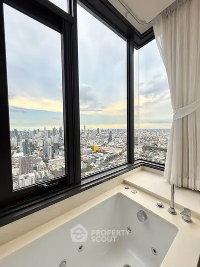 Luxurious bathroom with stunning city skyline view from high-rise window.