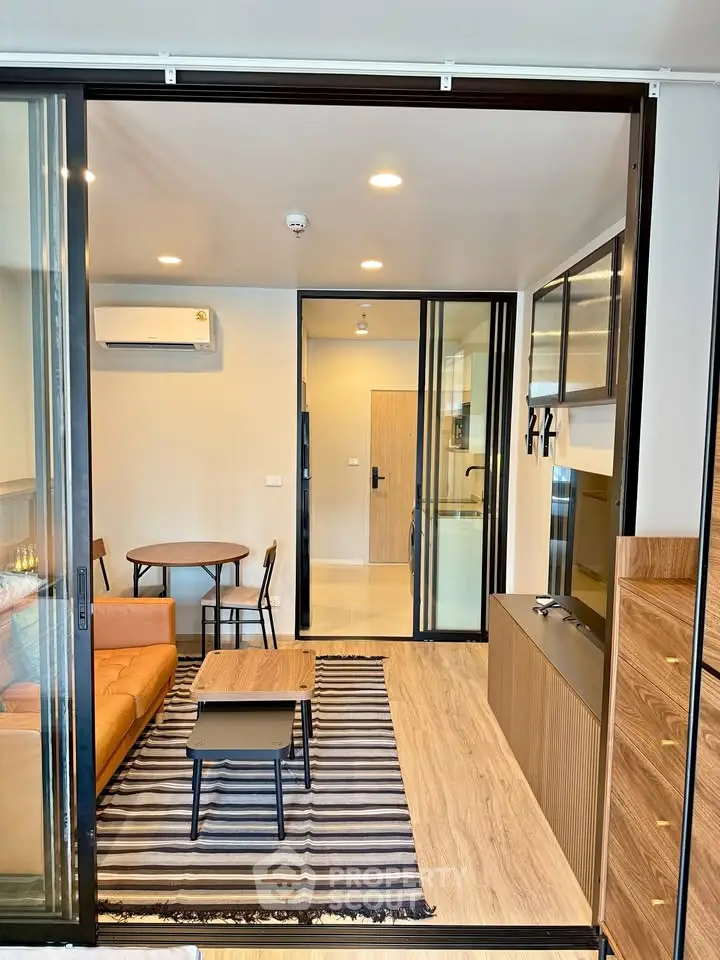 Modern living room with stylish furniture and open layout, featuring a cozy ambiance and sleek design.