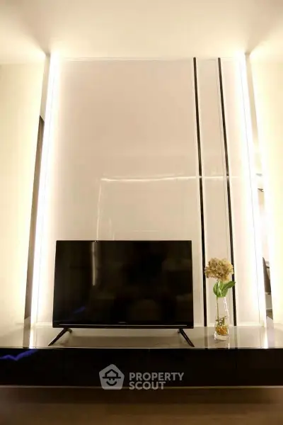 Modern living room with sleek TV setup and elegant lighting