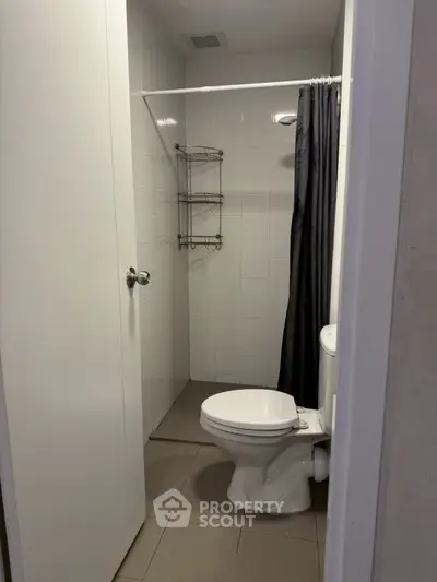 Compact bathroom with shower and modern fixtures in a real estate property.