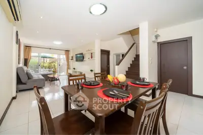 Spacious open-plan living and dining area with modern decor and natural light.