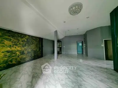 Spacious modern living room with marble flooring and unique wall design
