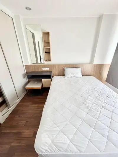 Modern bedroom with sleek design, featuring a comfortable bed and built-in storage solutions.