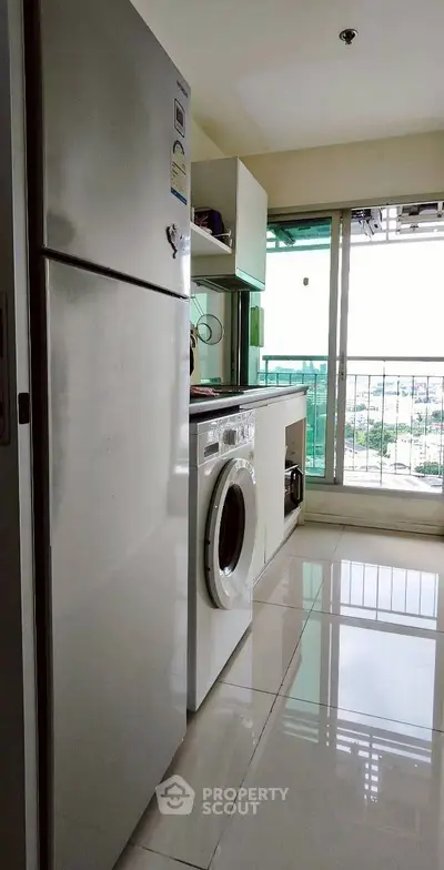 Modern kitchen with appliances and city view from window