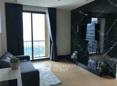 Modern living room with marble accent wall and balcony view