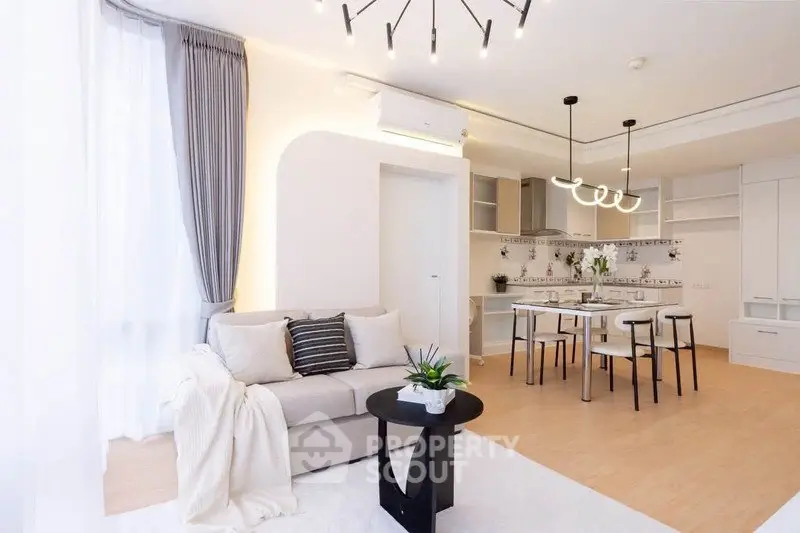 Modern open-layout living room with stylish decor and natural light