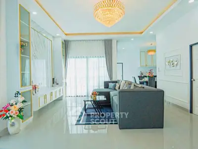 Luxurious modern living room with elegant chandelier and spacious seating area