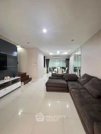 Spacious modern living room with elegant dining area and stylish decor.