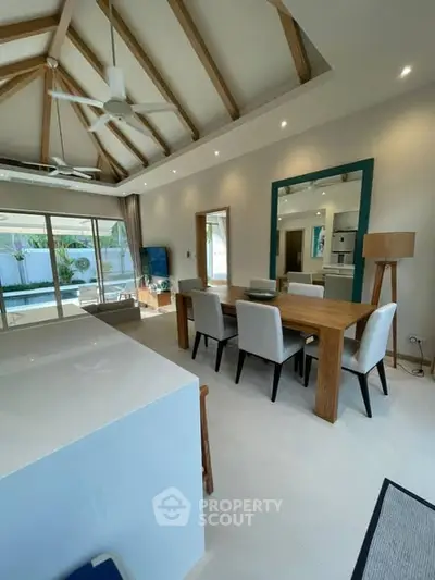 Spacious modern living room with high ceilings and elegant dining area in luxury home.