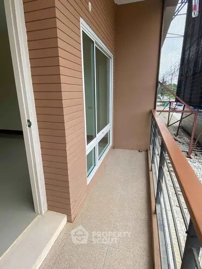 Charming balcony with modern railing and sliding glass doors, perfect for enjoying outdoor relaxation.