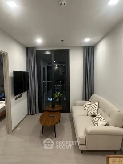 Modern living room with cozy sofa and stylish decor in a contemporary apartment.