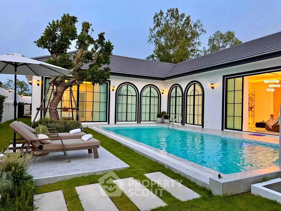 Luxurious modern villa with private pool and elegant outdoor seating area, perfect for relaxation.