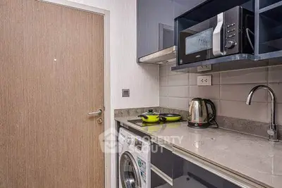 Modern compact kitchen with washing machine and microwave