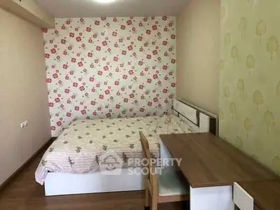 Cozy bedroom with floral wallpaper and wooden furniture