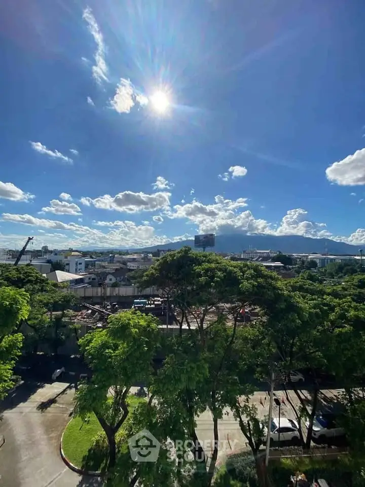 Stunning cityscape view with lush greenery and clear blue sky, perfect for urban living enthusiasts.
