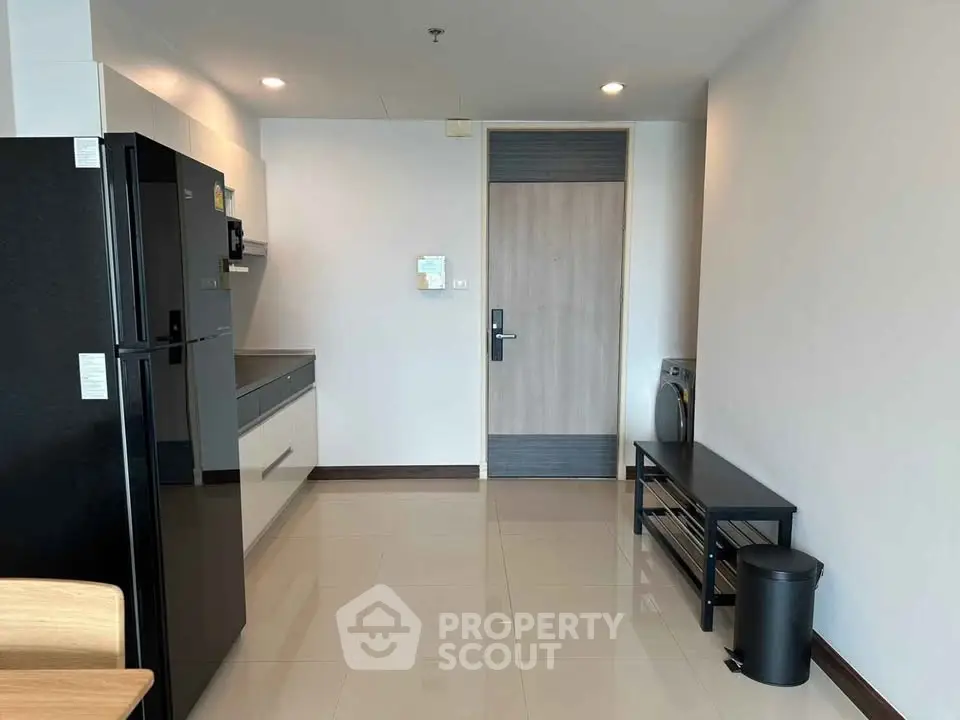 Modern apartment entrance with sleek kitchen and stylish furniture