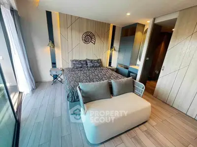 Luxurious modern bedroom with stylish decor and large windows offering natural light.
