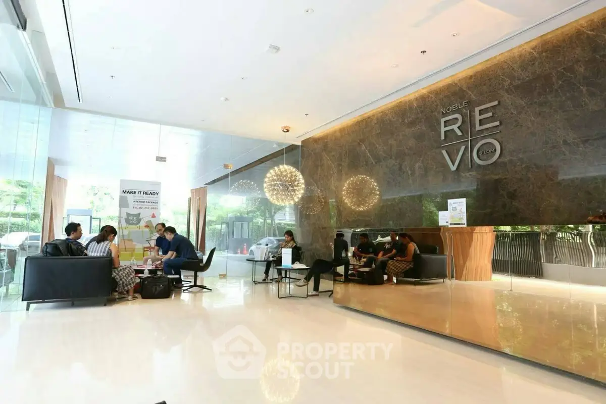Luxurious lobby area with modern seating and elegant lighting at Noble Revo building.
