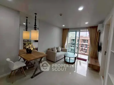 Modern living room with balcony view, stylish furniture, and elegant lighting in a contemporary apartment.