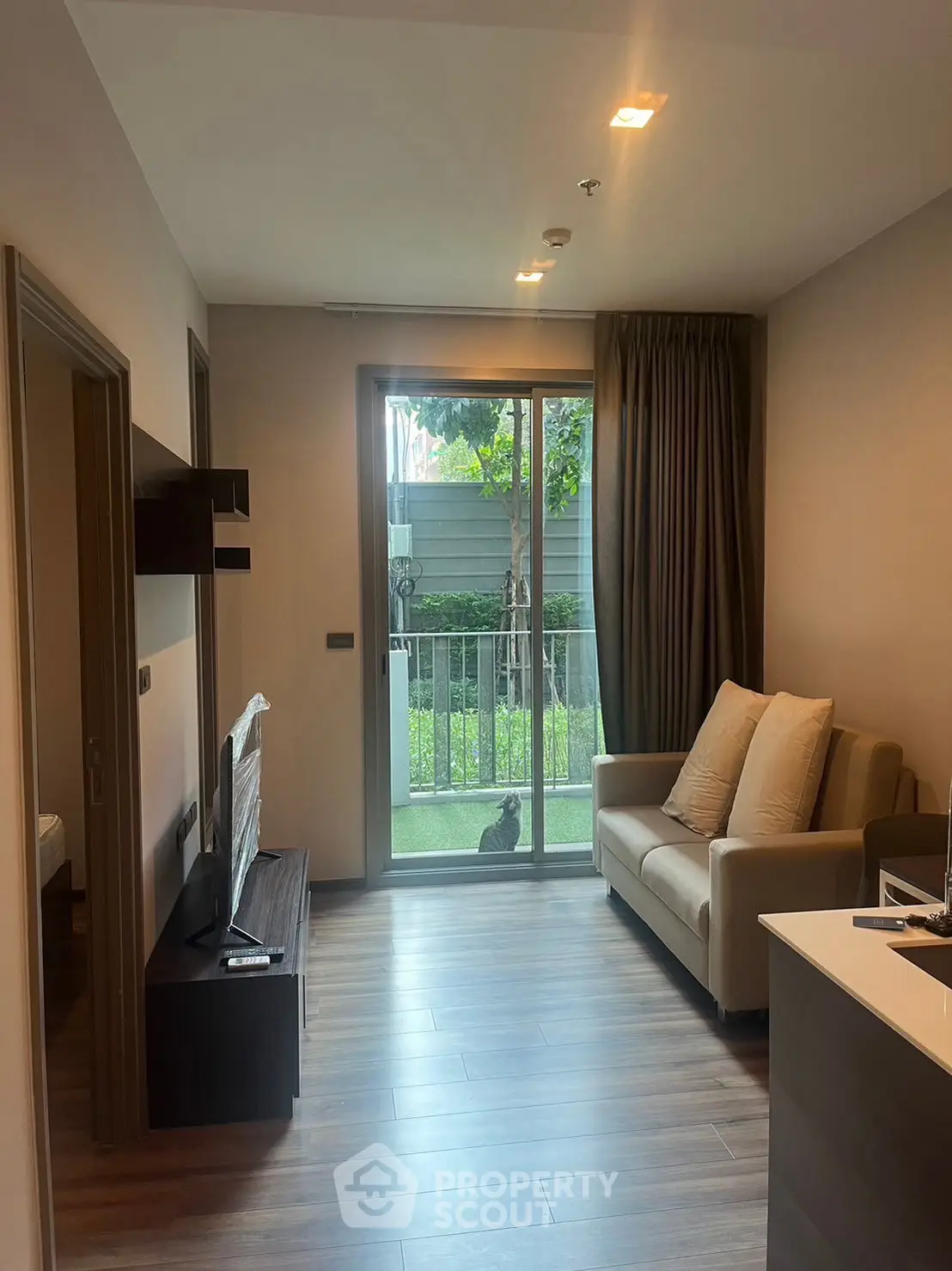 Modern living room with garden view and cozy sofa, perfect for relaxation.