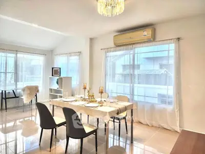 Elegant dining area with natural light and modern decor in a spacious home.