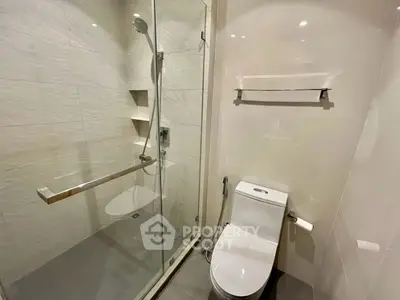 Modern bathroom with glass shower and sleek toilet design