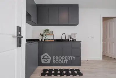 Modern kitchen with sleek black cabinets and minimalist design