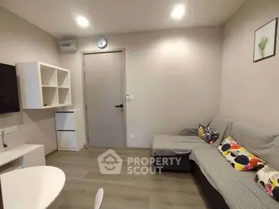 Modern living room with cozy sofa and stylish decor in a contemporary apartment.