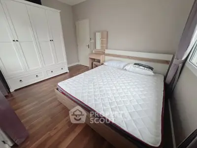 Spacious bedroom with modern furniture and large wardrobe