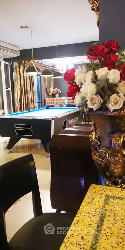 Luxurious living room with pool table and elegant decor, perfect for entertainment and relaxation.