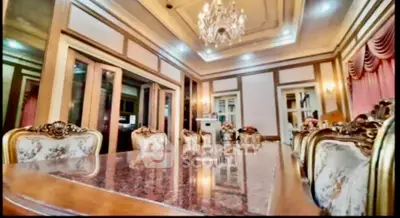 Luxurious dining room with elegant chandelier and ornate furniture, perfect for upscale gatherings.